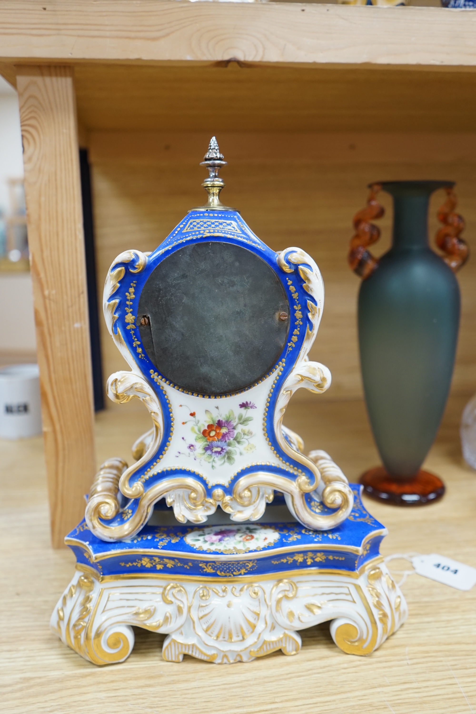 A French Paris porcelain waisted clock, striking on a bell, raised on original matching stand in the style of Jacob Petit c.1830, 37cm high. Condition - poor to fair